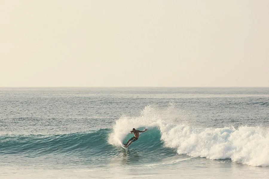 Surfer riding inside a wave barrel
